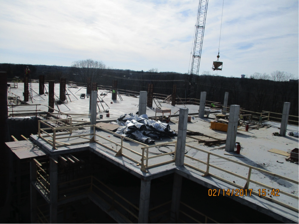 Building under construction aerial view with crane in the distance