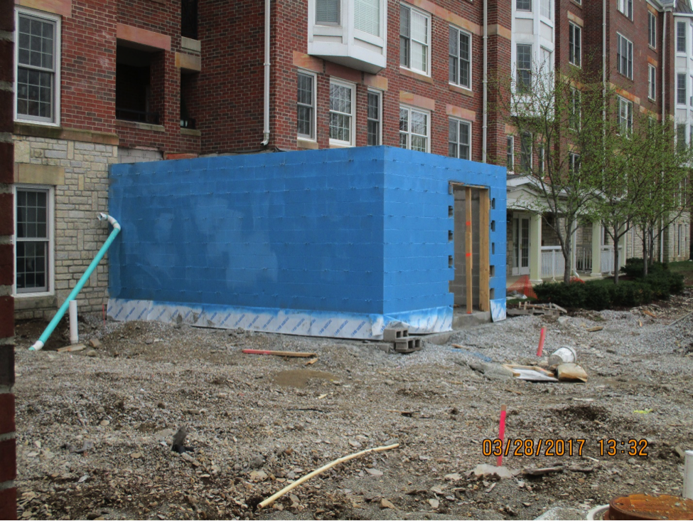 bistro under construction outside view with blue sheets covering framing