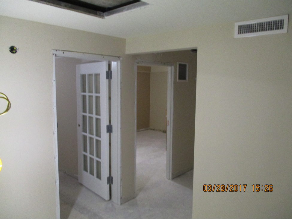 Inside of office with doors waiting for crown molding