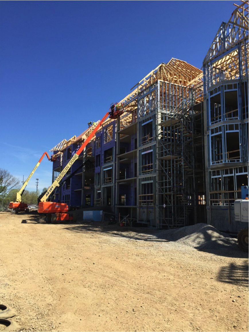 Outside view of frame work of riverstone with two cranes in sight
