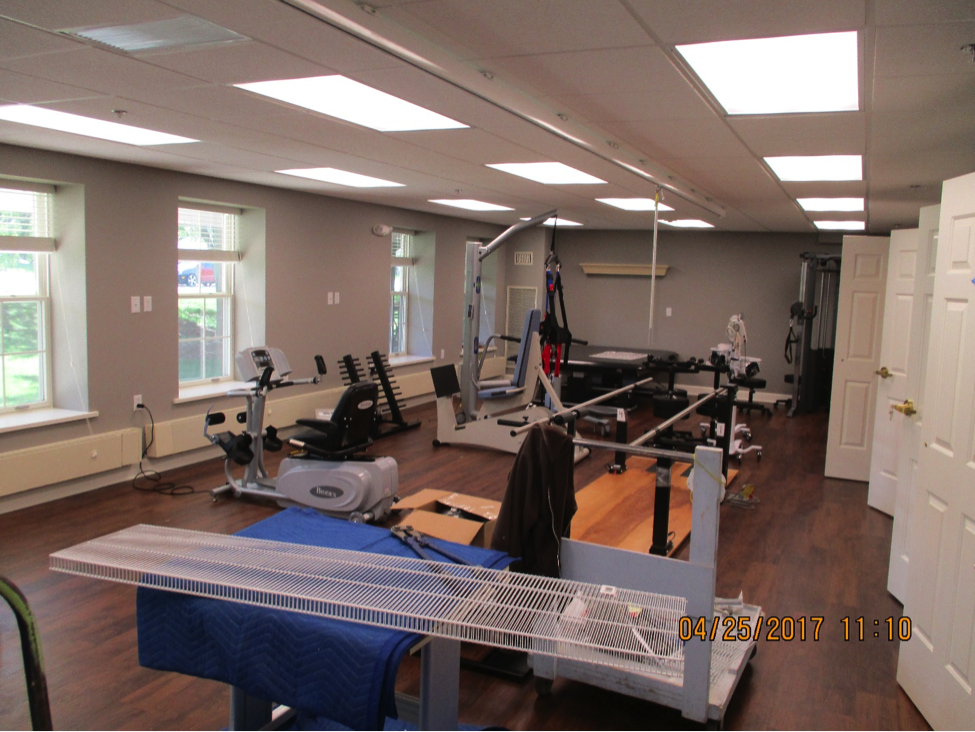 Exercise equipment in a room with wood floors