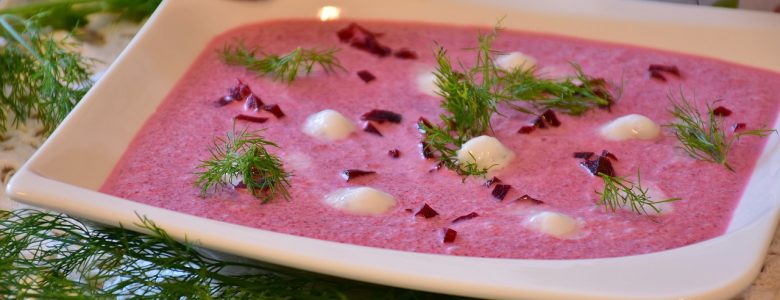 pink soup in a white serving bowl