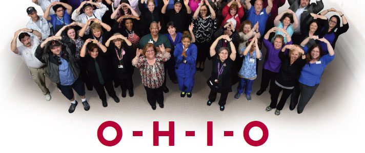 Group of people spelling out "O-H-I-O" with their arms