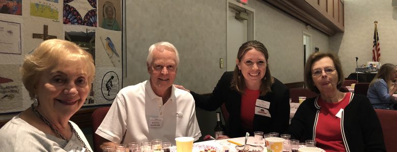 Residents enjoying wine at a table together