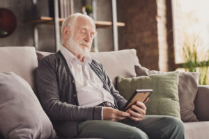 Lonely older man looking at old photo