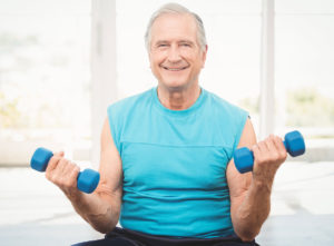 Older man lifts weights to improve emotional wellness