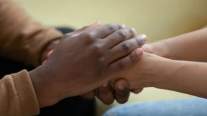 Compassionate touch holding hands
