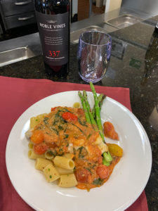 plate of pasta with asparagus and wine