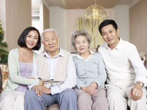 Two generations of Asian family on couch