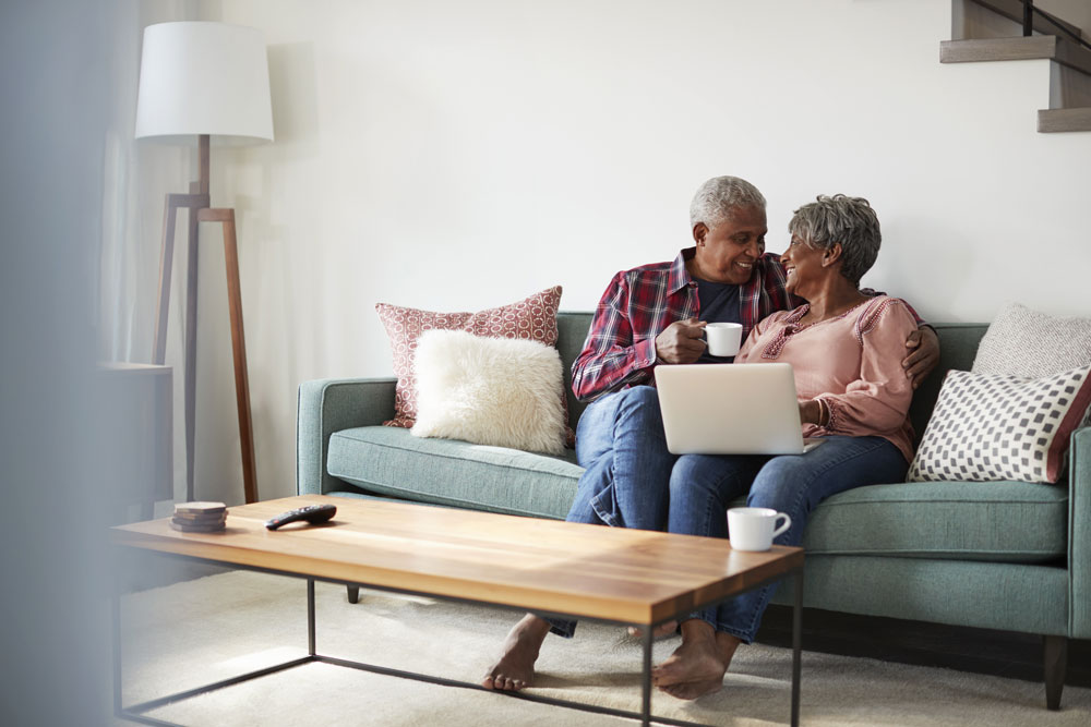 older african american couple exploring senior living options on a computer