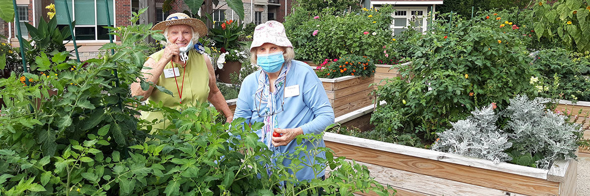 Working in the resident gardens promotes environmental wellness for two women