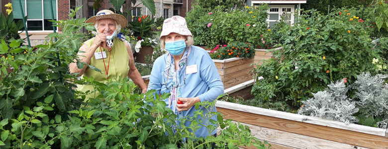 Working in the resident gardens promotes environmental wellness for two women