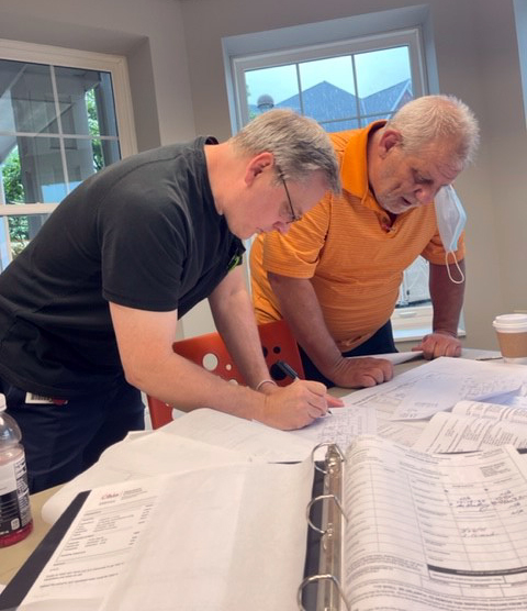 maintenance associates examining schematics