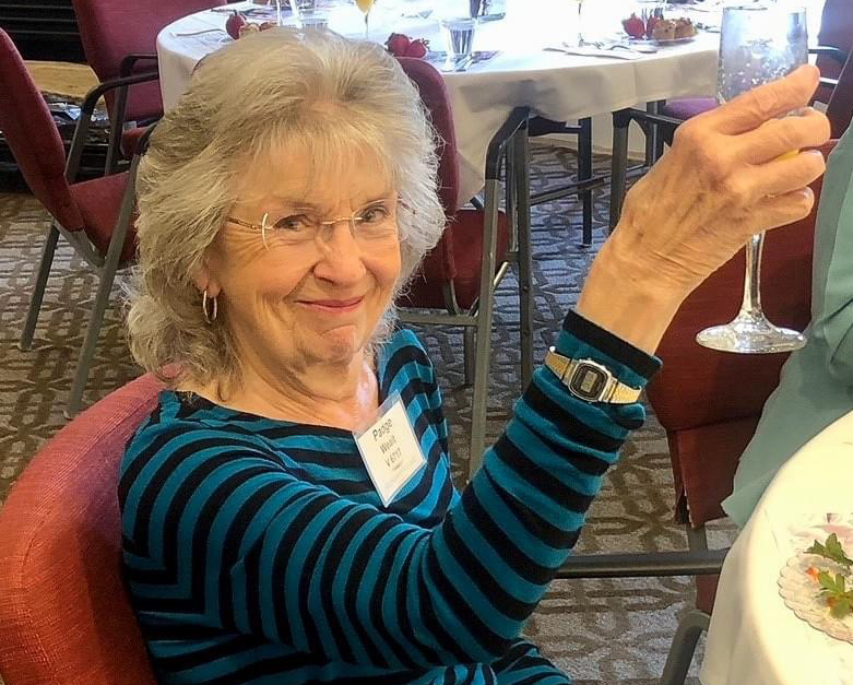 senior woman raising champagne glass