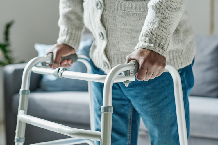 senior using a walker to prevent falls