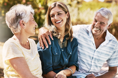 senior couple talking to adult daughter