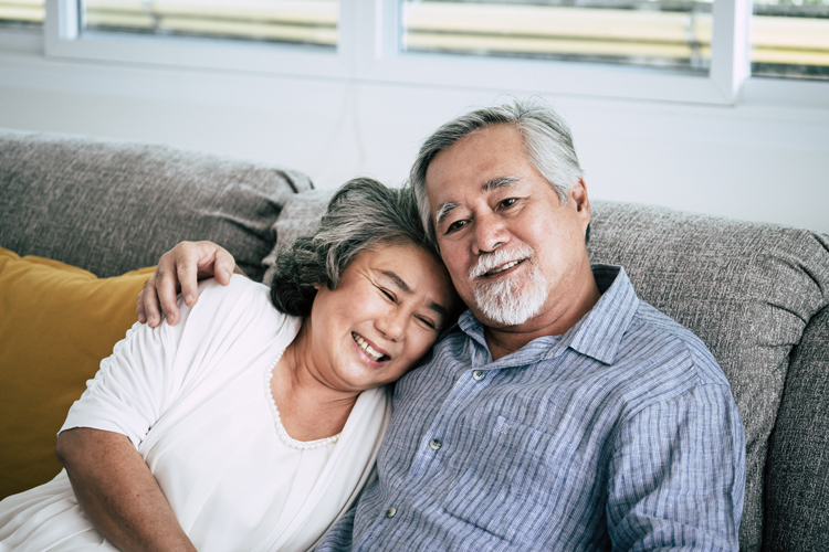 happy couple relaxing in their apartment in a senior living community