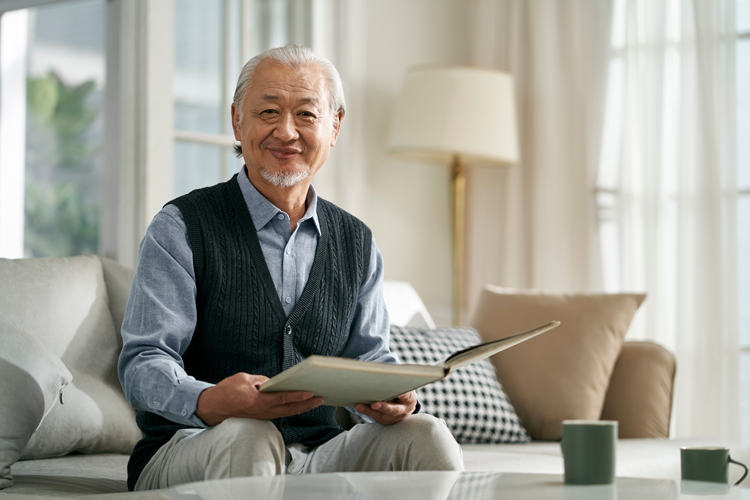 Older Asian man content at home