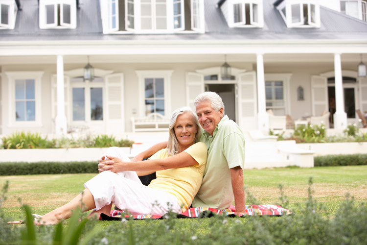 senior couple aging in place in front of their home