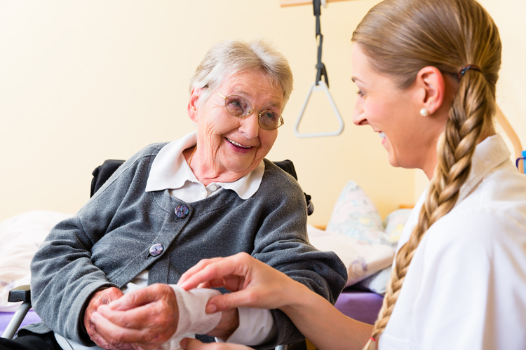 Nurse providing wound care in senior living community