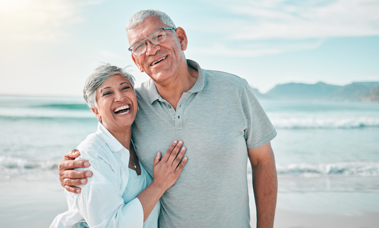 Senior couple enjoying retirement on their terms at the beach