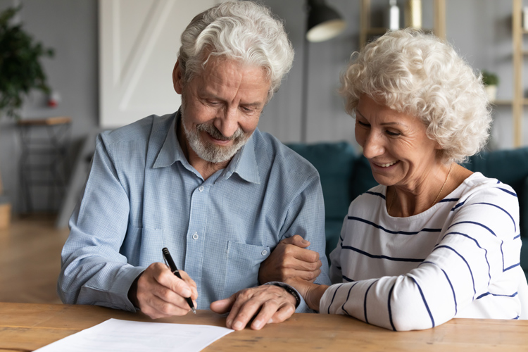 Older couple signing papers