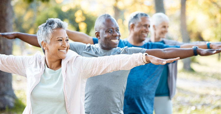 A group of seniors exercising to promote wellness.