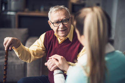 Home care worker assists man with dementia with mobility