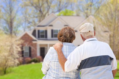 Older couple looking at their home.