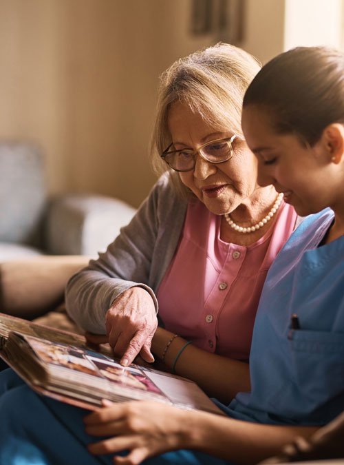 Caregiver helps resident in a memory care community