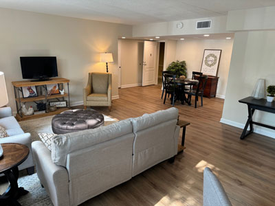 The spacious open-concept living and dining room in The Middleton independent living apartment.