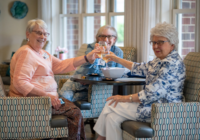 Friendship Village of Dublin Residents toasting one another.