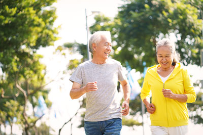 Older Asian couple jogging