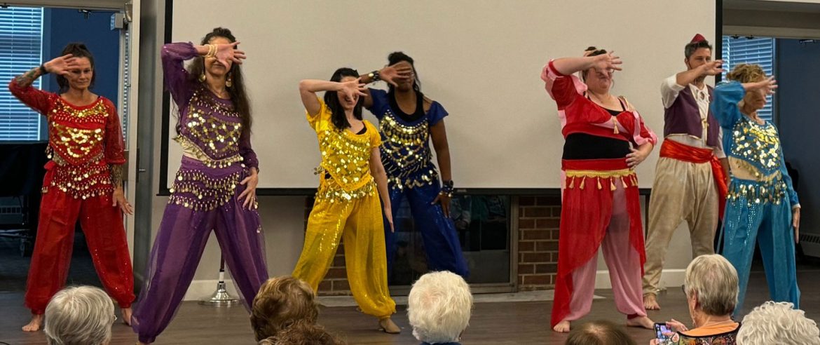 Staff members perform an dance to kick off Active Aging Week