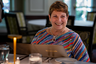 Woman enjoying dinner at The Riverwalk at Friendship Village of Dublin.