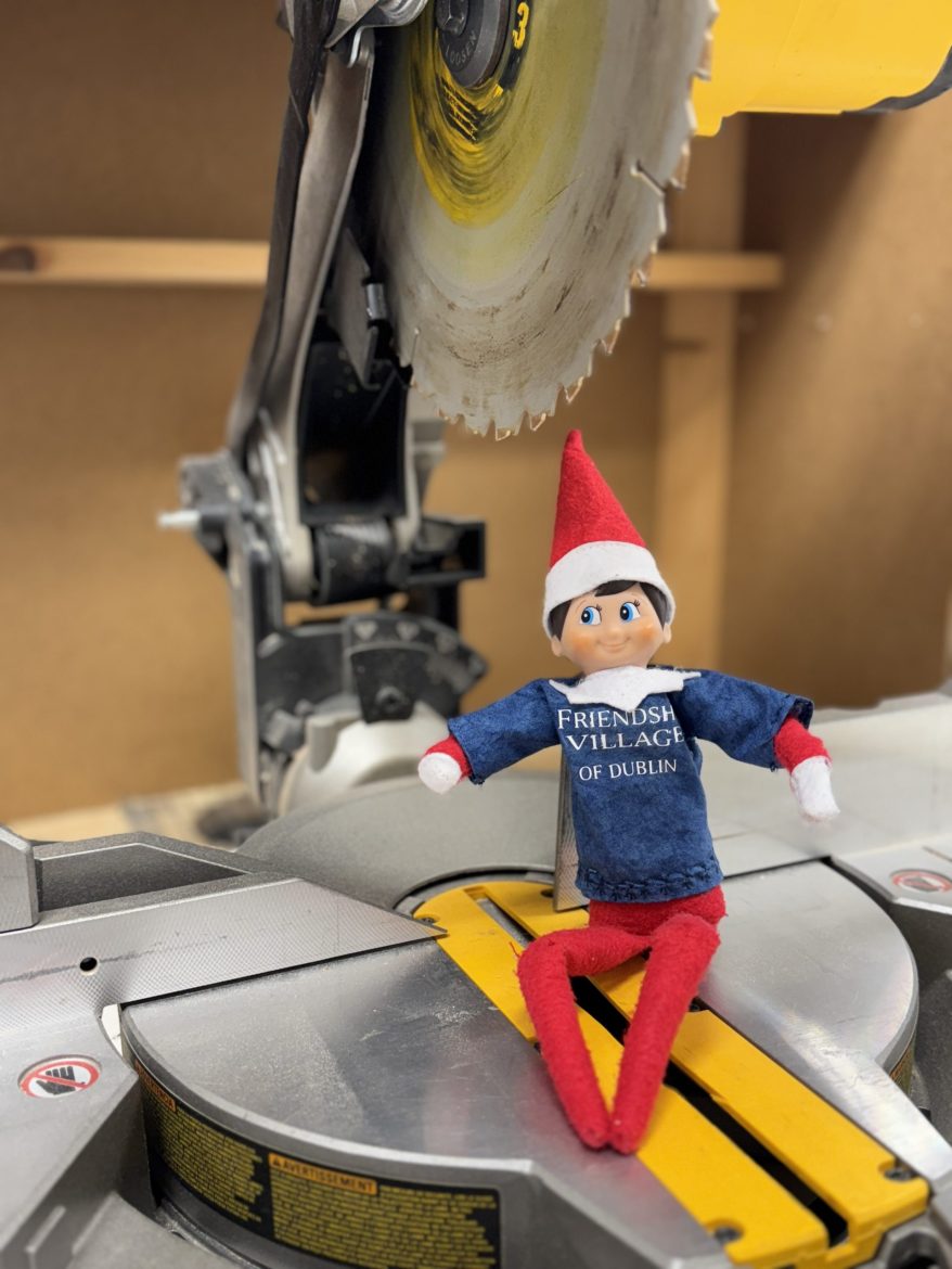 Friendly the Elf on a saw in the wood workshop at Friendship Village of Dublin.