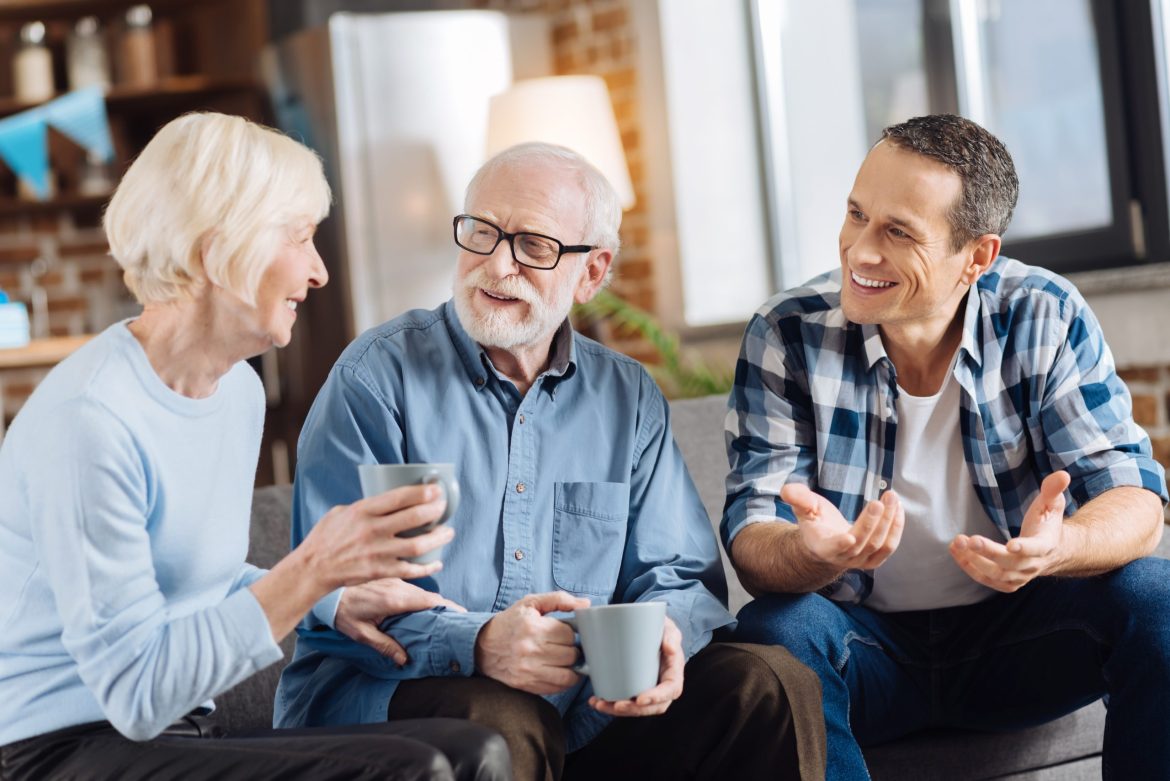 An older couple talks to their son about senior living options