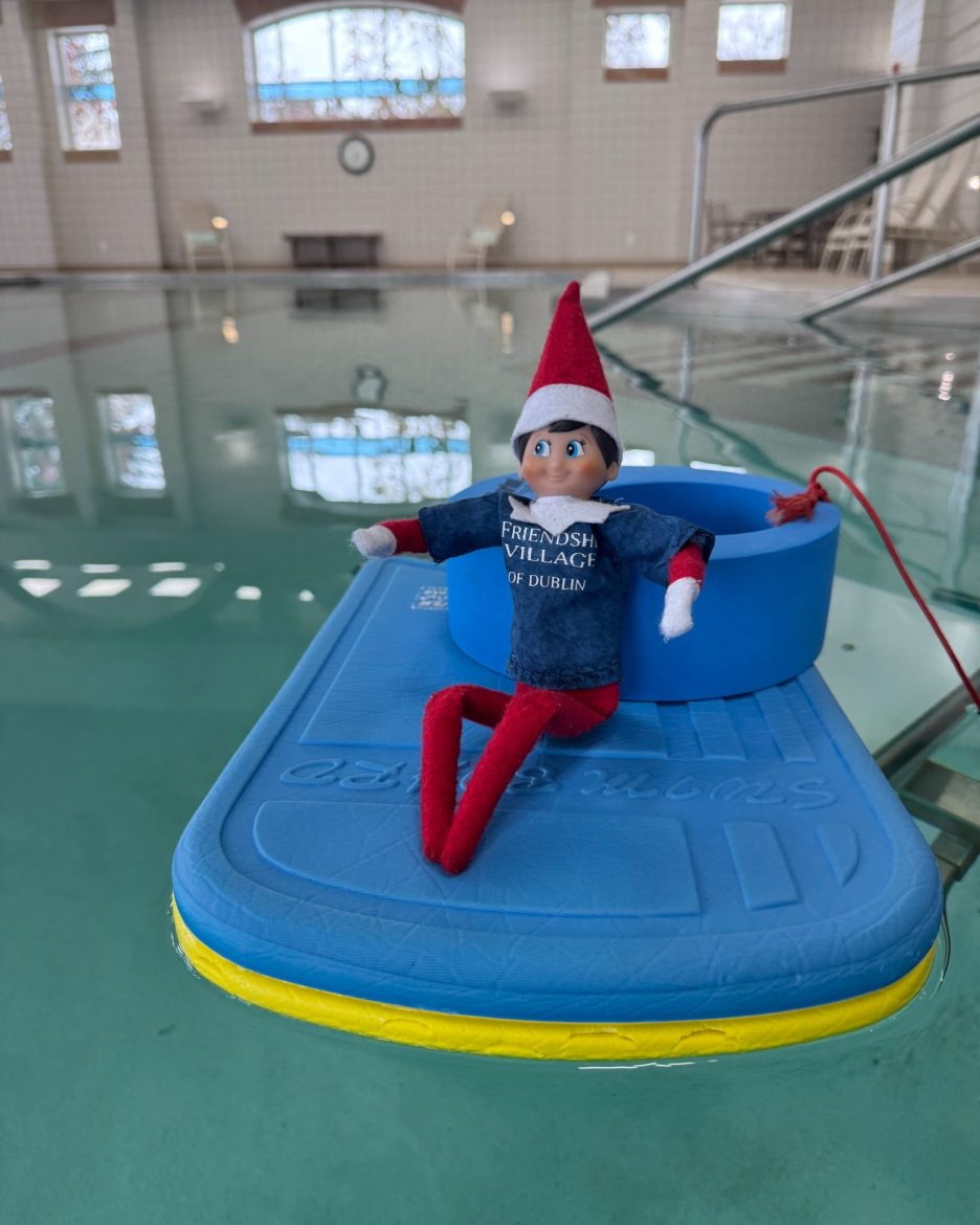 Friendly the Elf lounges on a pool float at Friendship Village of Dublin