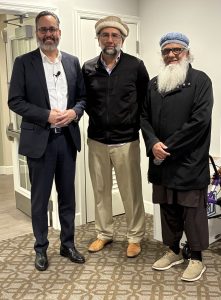 Chaplain Fred Arzola stands next to two make Muslim community leaders