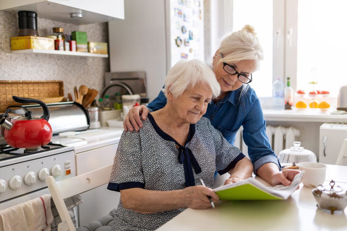 A daughter helps her mother with dementia complete a task.