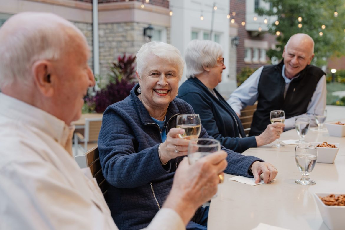 Independent living Residents toasting with wine glasses.