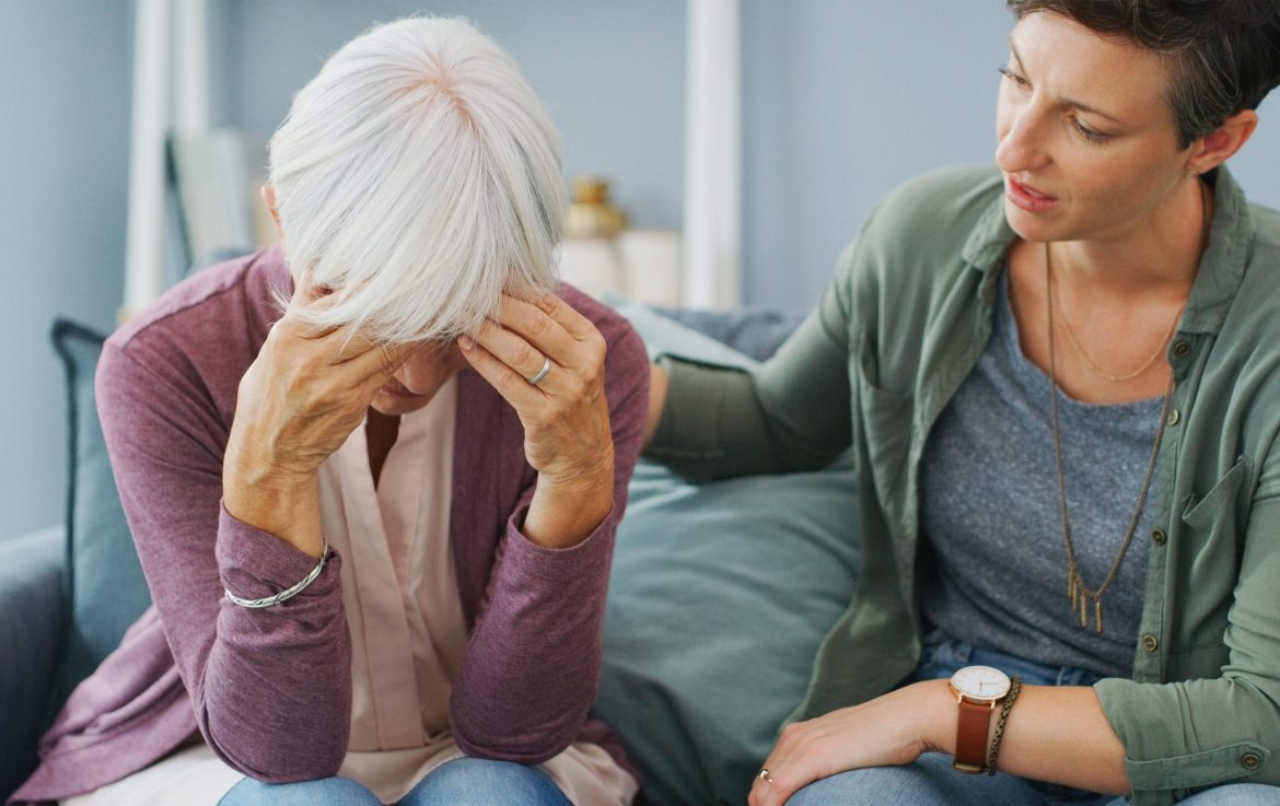 Daughter comforts her mother who is living with dementia.