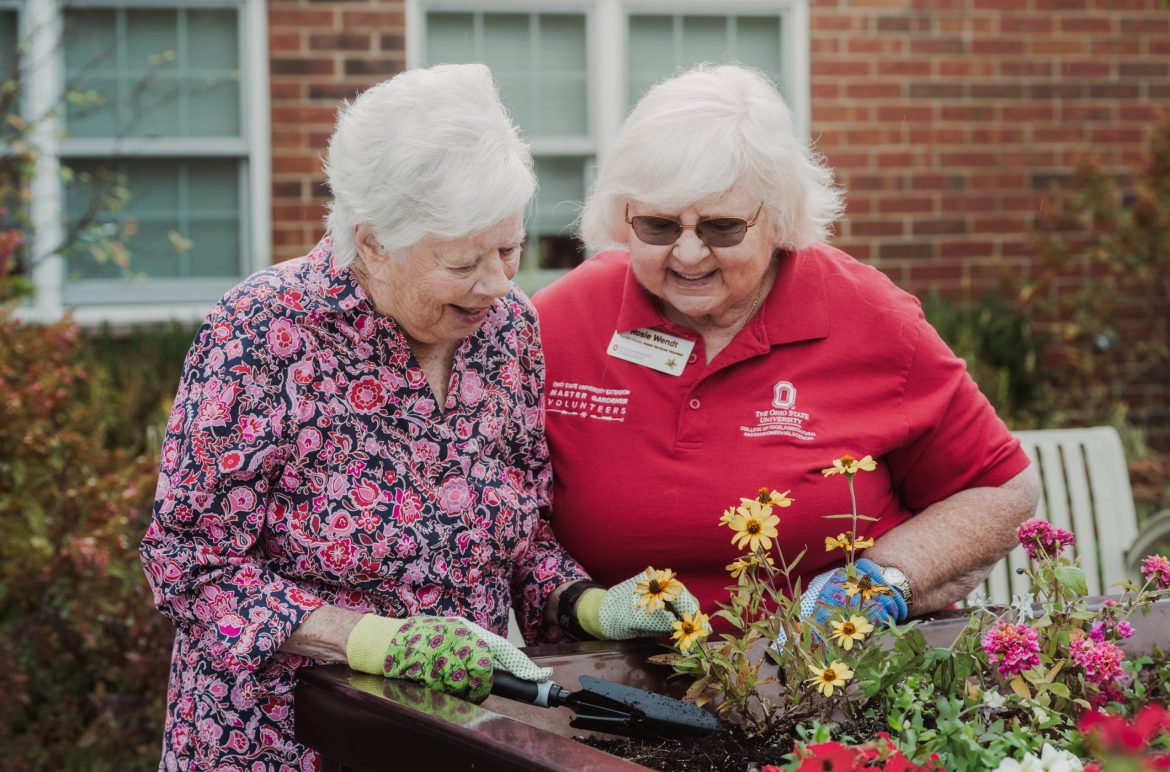 Volunteer with the OSU Master Gardener program works with Resident of Rowan House Memory Care.