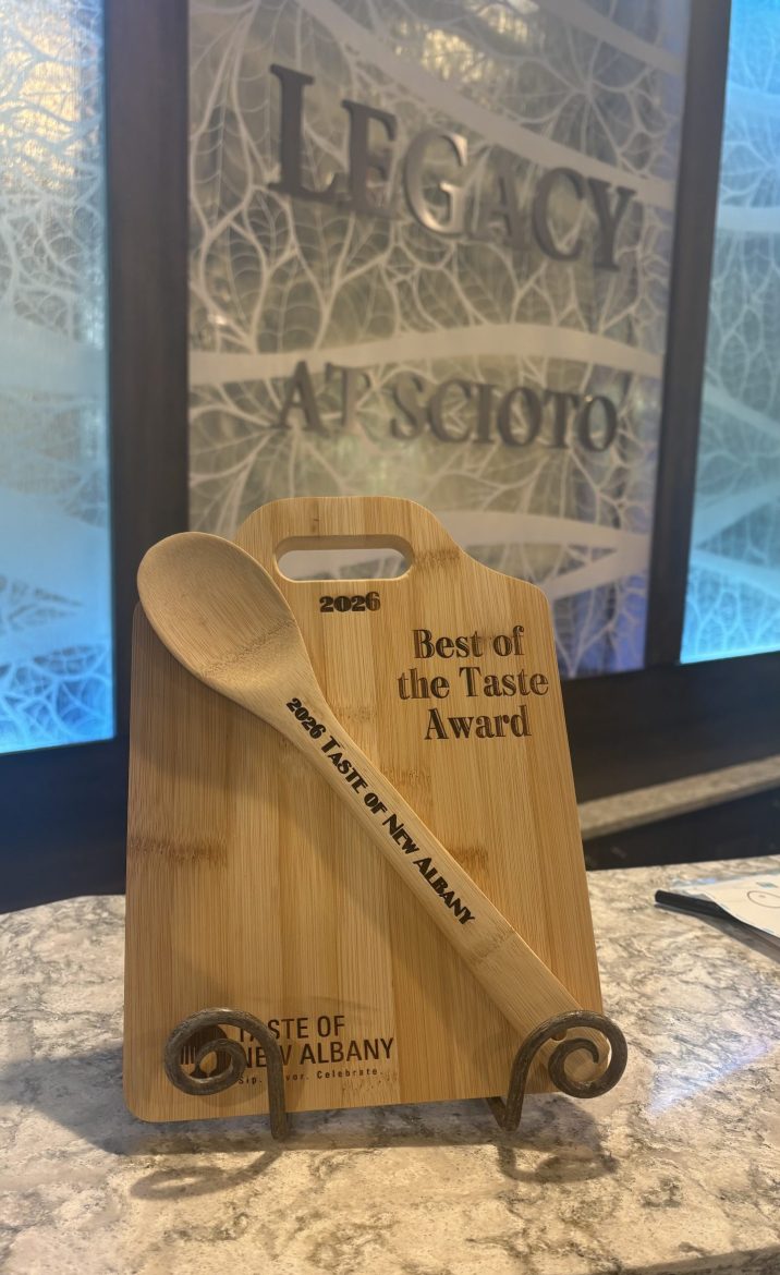 The award for the 2026 Taste of New Albany, a cutting board and wooden spoon with "2026 Taste of New Albany, Best of Taste Award" inscribed on it.